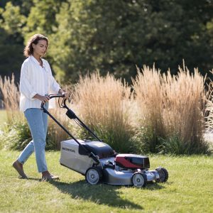 lady mowing lawn with HRG466XB battery Honda mower