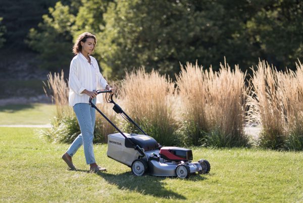 lady mowing lawn with HRG466XB battery Honda mower